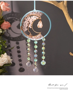 Detail of moon suncatcher with pink quartz tree of life and crystal ball prism