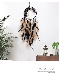 Detail of bohemian dream catcher with black tree of life design and natural feathers