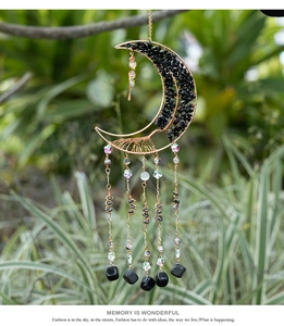 Detail der mondförmigen Lebensbaum Wanddeko mit schwarzen Steinen und Metallketten
