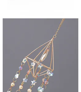 Detailed shot of golden geometric suncatcher featuring star crystals and beads