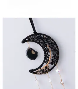Detail of moon-shaped suncatcher with Tree of Life wire wrap and black crystals