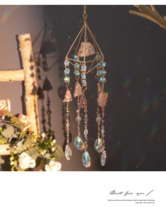 Detail of geometric suncatcher with purple amethyst raw stones and prism crystal pendant