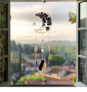 Detail of moon-shaped tree of life suncatcher with black stones and agate pendant