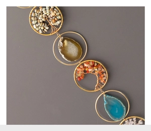 Detail of handmade Tree of Life ornaments with colorful agate slices and wire-wrapped stones