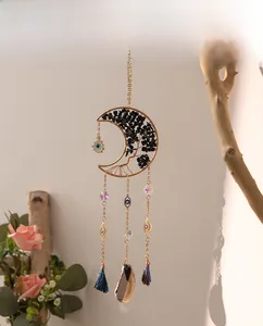 Detail of moon suncatcher featuring Tree of Life weaving with obsidian and evil eye charms