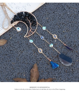 Detail of moon suncatcher with tree of life design and blue evil eye beads decor