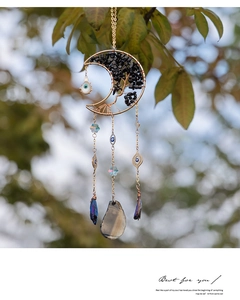 Detail of moon suncatcher with tree of life, evil eye and colorful crystal prisms