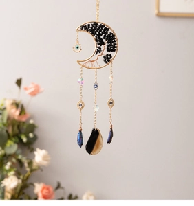 Detail of moon suncatcher with black stones tree of life and evil eye crystal beads