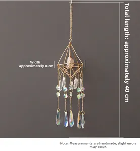 Detailed view of crystal suncatcher with gold octahedron frame and teardrop prism pendants