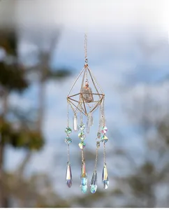 Detailed sun catcher with geometric gold frame, raw stone, and rainbow prism crystals