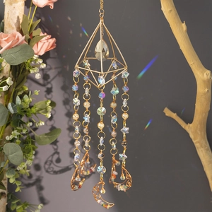 Gold crystal suncatcher with moon-shaped pendant and colorful stones for window decor