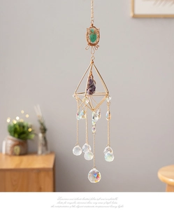 Detail of crystal suncatcher with gold owl motif and colorful agate stone pendants