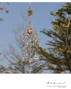 Detail of geometric suncatcher with natural raw stones and faceted crystal prisms