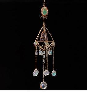 Detail of golden geometric suncatcher with purple crystal and colorful glass drops