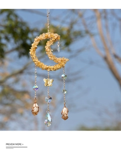 Macro detail of moon suncatcher with citrine stones and butterfly crystal pendants