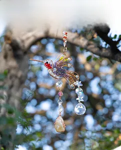 Detailed hummingbird suncatcher with colorful crystal beads and a natural raw stone pendant