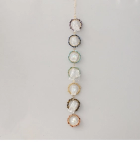 Vertical wall decor featuring seven chakra natural crushed stones and raw crystal points