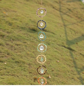 Detail of seven chakra crystal dream catcher with colorful stones and prisms