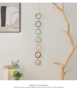 Close-up of seven chakra natural stone dream catcher with faceted crystal pendants