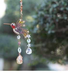 Detail of hummingbird sun catcher with colorful beads and crystal stones for garden decor