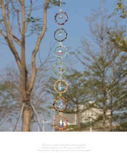 Detail of seven chakra crystal dream catcher with natural stones and hanging prisms