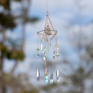 Crystal suncatcher with gold geometric frame and rainbow prism drops for garden decor