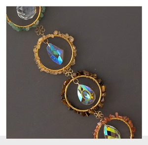 Detailed macro of golden dream catcher rings with natural crystal stones and teardrop beads