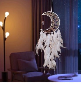Detail of moon dreamcatcher with tree of life crystals and soft white feathers decor