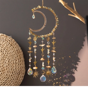 Macro view of crystal moon suncatcher with raw citrine stones and rainbow prism pendants
