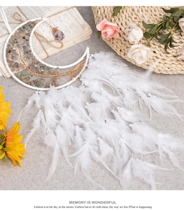 Detail of moon-shaped dream catcher with white feathers, crystals and tree of life weaving