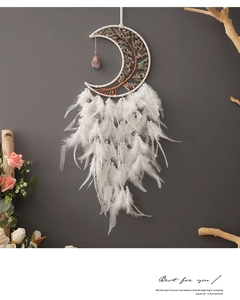 Detail of moon dreamcatcher featuring life tree metalwork and white feathers decor