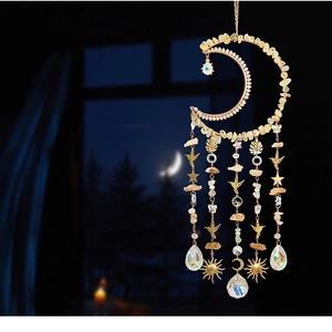 Macro detail of moon-shaped suncatcher with natural stones and multifaceted crystal