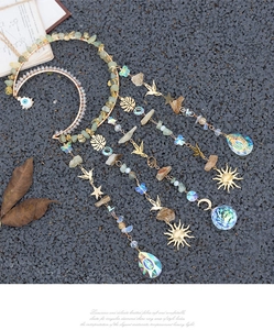 Detail of handmade crystal dream catcher with evil eye, natural stones and rainbow prisms