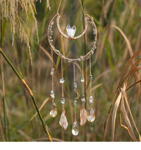 Detailed close-up of handmade crescent moon crystal suncatcher with gold wire and stones