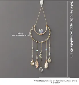 Detail of bohemian moon wall decor with natural crushed stones and crystal prisms
