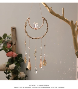 Macro view of crystal moon suncatcher with tree of life and natural crushed stones