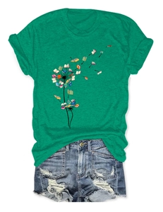 Flat lay of dandelion print t-shirt made of flying books with distressed denim shorts