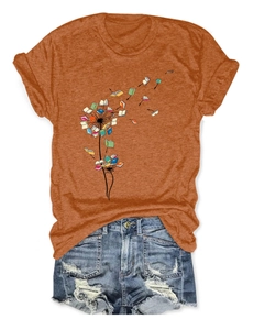 Close-up of ginger orange dandelion book print t-shirt paired with denim shorts