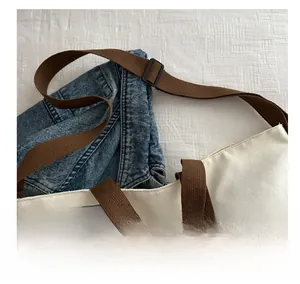 Detail of reinforced brown woven strap and printed canvas tote bag interface