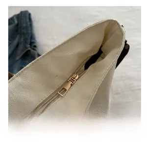 Macro detail of high-quality smooth metal zipper and brown canvas strap on tote bag