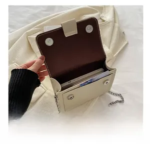 Detail view of cream crossbody bag interior showing space for smartphone and cards