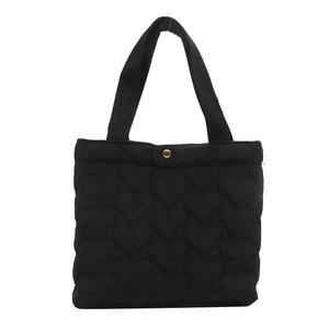 Large black heart-quilted tote bag with golden buckle and twin handles for women