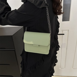 Mint green crossbody chain bag with topstitch detailing and stylish metal strap