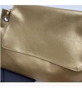 Detail of soft leather shoulder bag featuring FASHION BAGS logo and silver chain strap