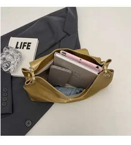Internal view of spacious gold tote bag showing storage for tablet and umbrella