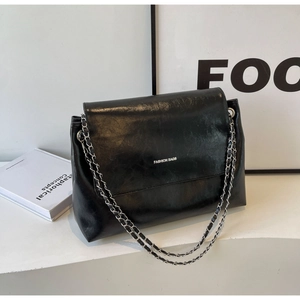 Retro black patent leather tote bag with silver chain strap and front logo print