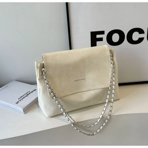 Detail of cream flap shoulder bag with metal chain strap and minimalist logo