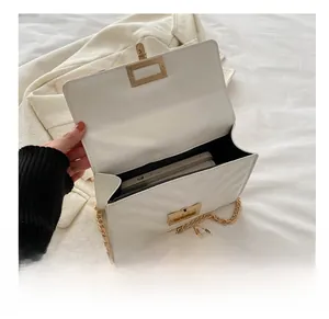 Interior view of white quilted chain bag showing space for a smartphone and gold clasp