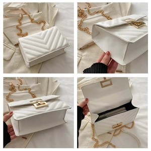 Detail view of white quilted flap bag with gold chain strap and square metal rotary lock