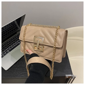 Detail of beige quilted leather handbag with gold chain strap and metallic square lock
